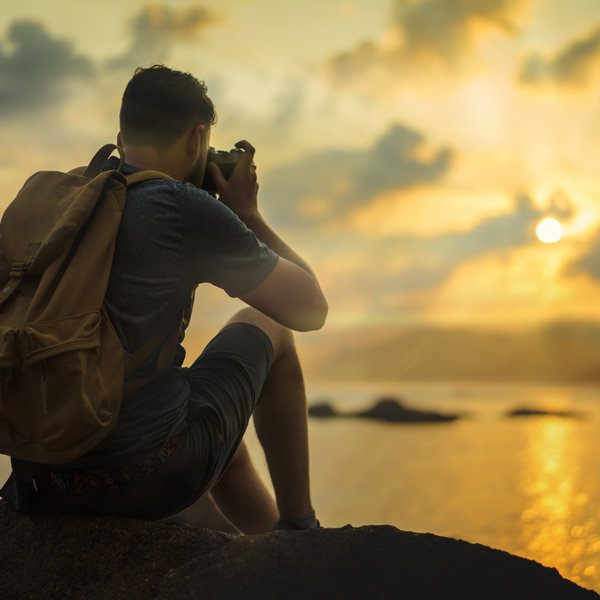 Young man traveling and learning with a camera